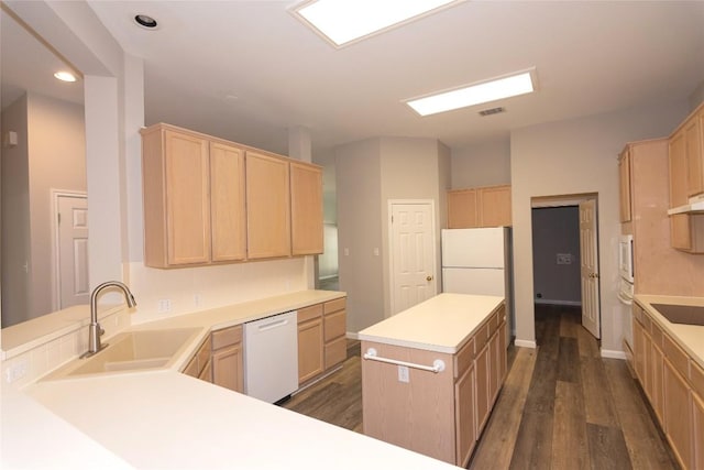 kitchen featuring dark wood-type flooring, white appliances, sink, and light brown cabinets