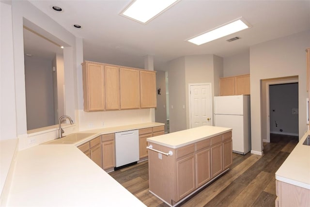 kitchen with sink, white appliances, dark hardwood / wood-style floors, a center island, and light brown cabinets