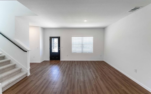 215 Tokalaun Dr, Hutto, TX 78634 - entryway featuring dark wood-style floors and stairway