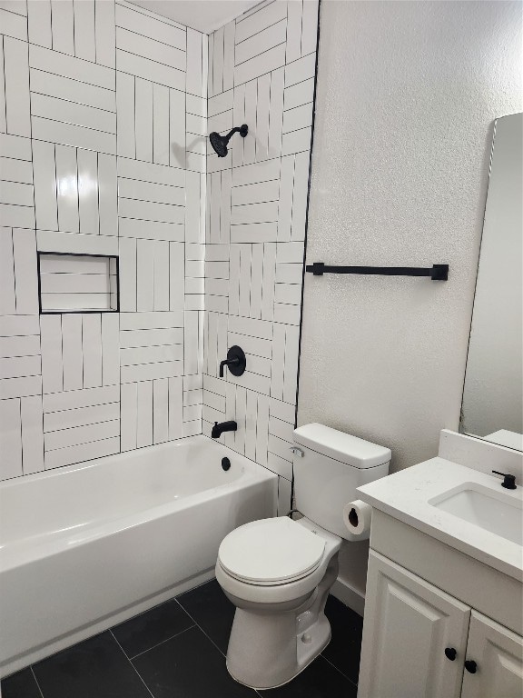 full bathroom with toilet, tiled shower / bath combo, vanity, and tile patterned floors