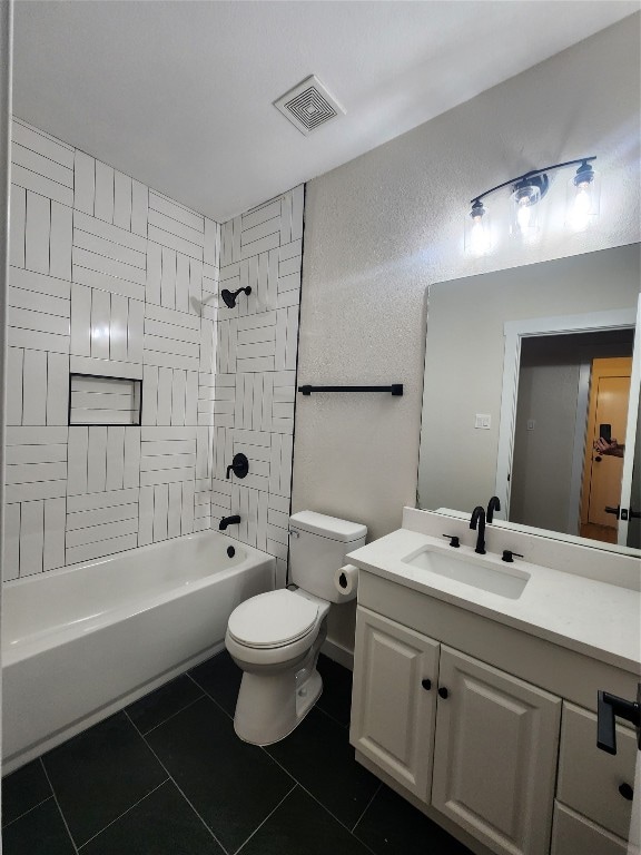 full bathroom with tile patterned flooring, toilet, vanity, and tiled shower / bath