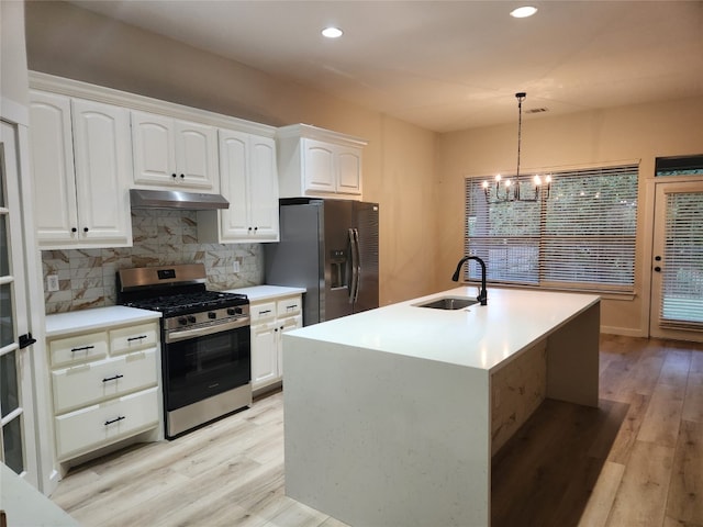 kitchen featuring light hardwood / wood-style floors, sink, stainless steel gas range, and black fridge