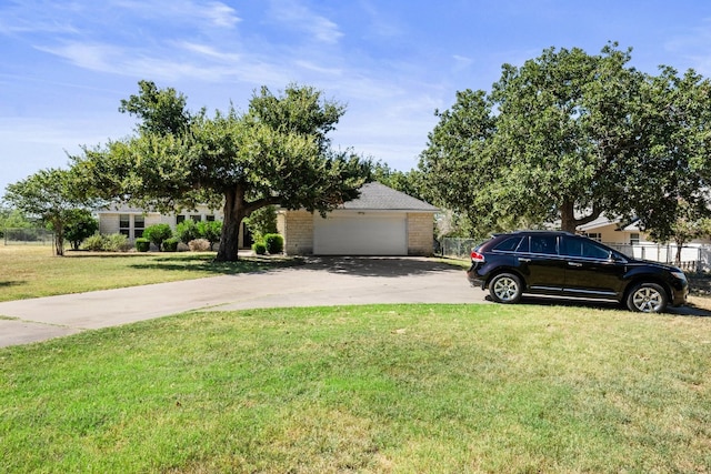 view of front of property featuring a garage and a front yard