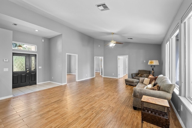 living room with light tile patterned flooring, high vaulted ceiling, and ceiling fan