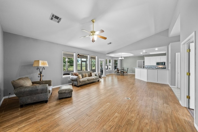 living room featuring ceiling fan, high vaulted ceiling, and light hardwood / wood-style flooring