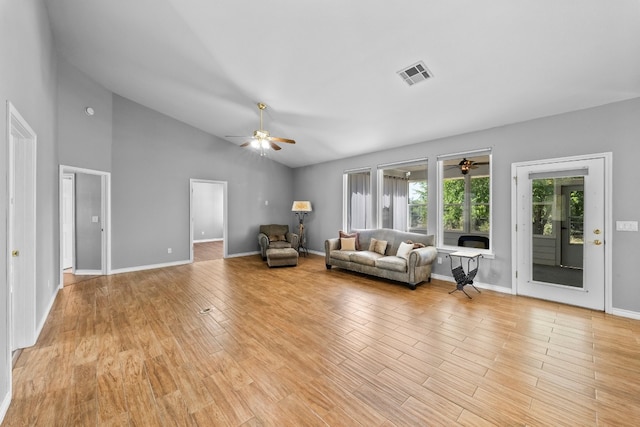 unfurnished living room with ceiling fan, high vaulted ceiling, and light hardwood / wood-style flooring