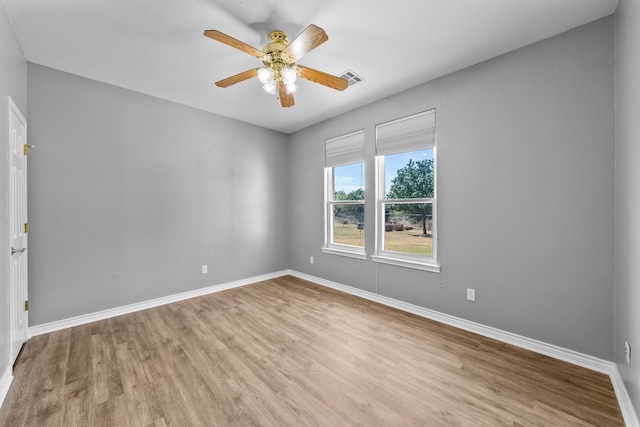 spare room with ceiling fan and wood-type flooring