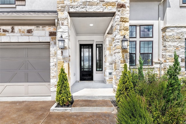 doorway to property with a garage