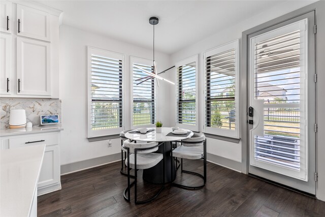 dining room with dark hardwood / wood-style flooring