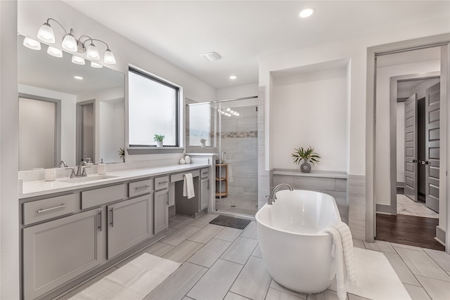 bathroom featuring vanity and shower with separate bathtub