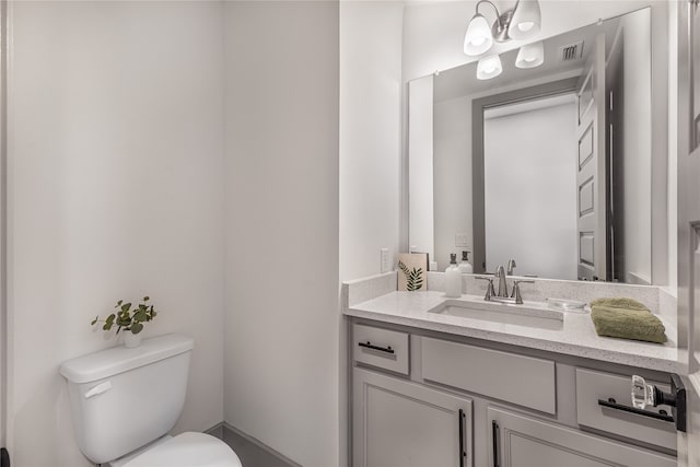 bathroom featuring toilet and vanity