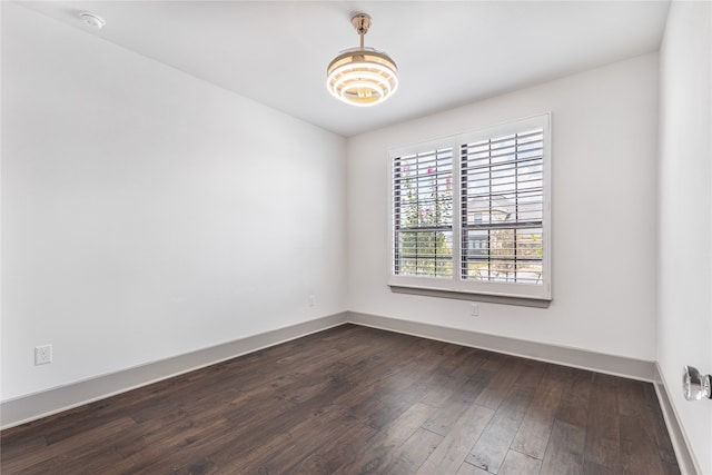 empty room with dark hardwood / wood-style flooring