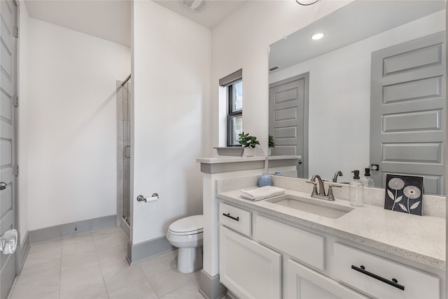 bathroom featuring toilet, vanity, and walk in shower