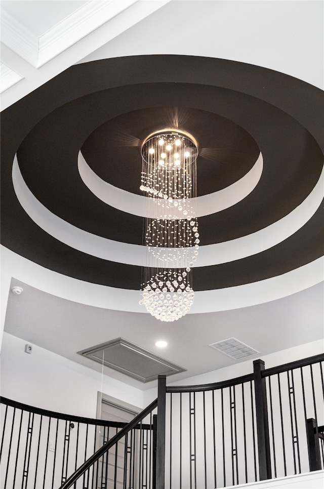 interior space featuring a raised ceiling and a notable chandelier