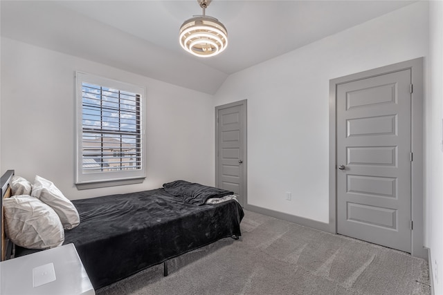 carpeted bedroom featuring lofted ceiling