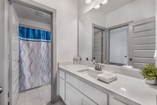 bathroom featuring vanity, tile patterned flooring, and curtained shower