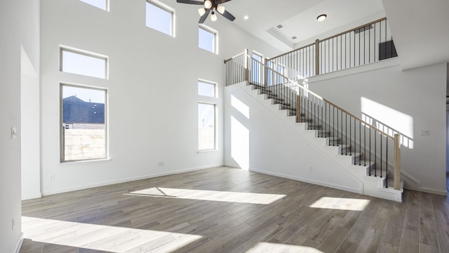 unfurnished living room with plenty of natural light and a high ceiling