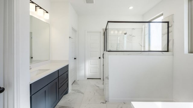 201 Menlo Bnd, Liberty Hill, TX 78642 - bathroom featuring marble look tile flooring, a marble finish shower, vanity, and recessed lighting