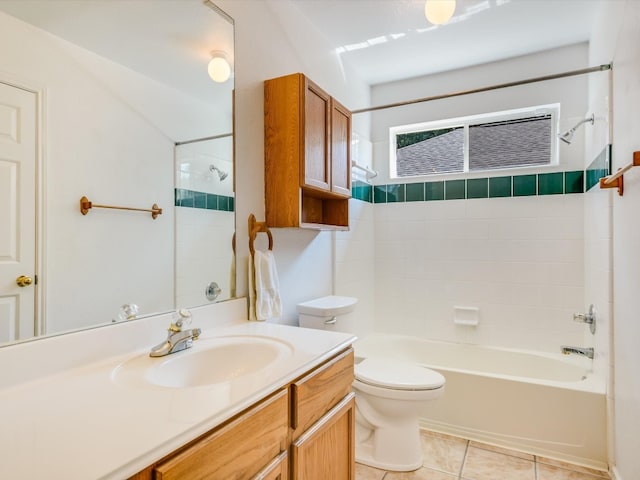 full bathroom featuring tiled shower / bath, vanity, tile patterned flooring, and toilet