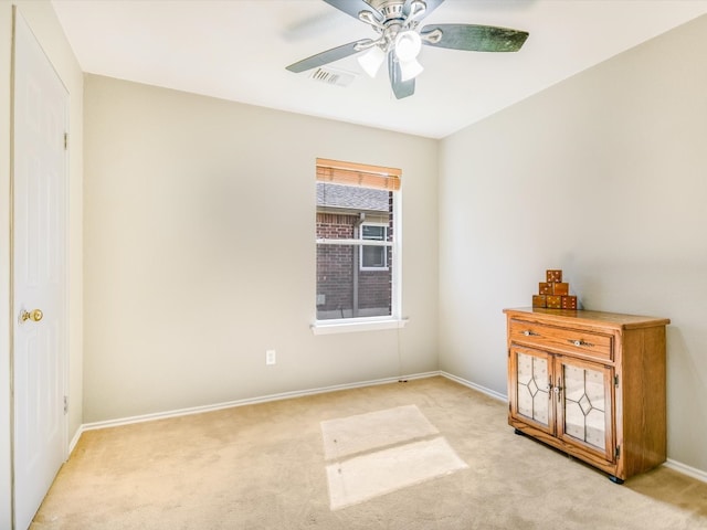 unfurnished bedroom featuring light carpet and ceiling fan