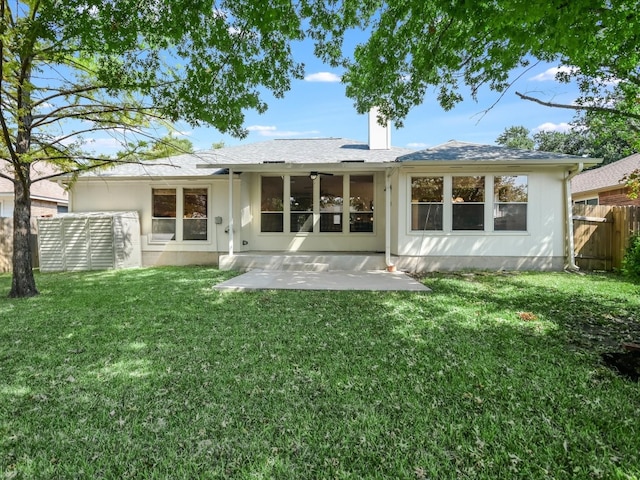 rear view of property featuring a patio area and a yard