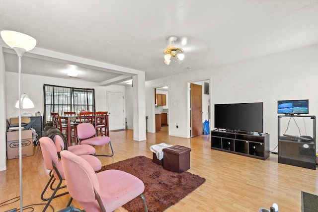 living room featuring light wood-type flooring and ceiling fan