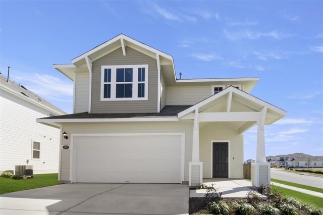 front of property with central AC and a garage