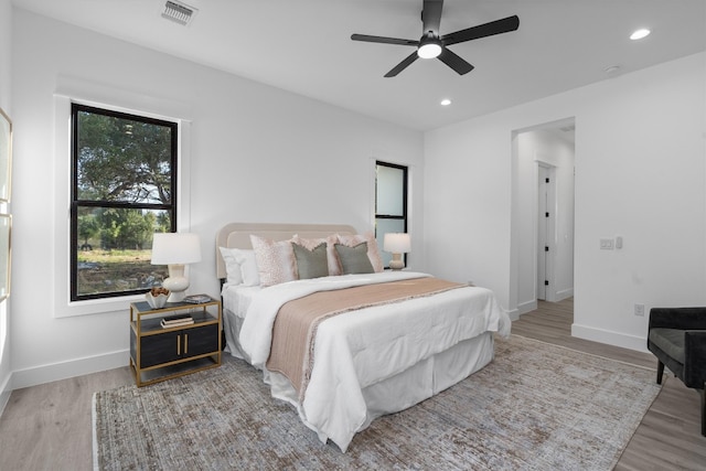 bedroom featuring hardwood / wood-style floors and ceiling fan