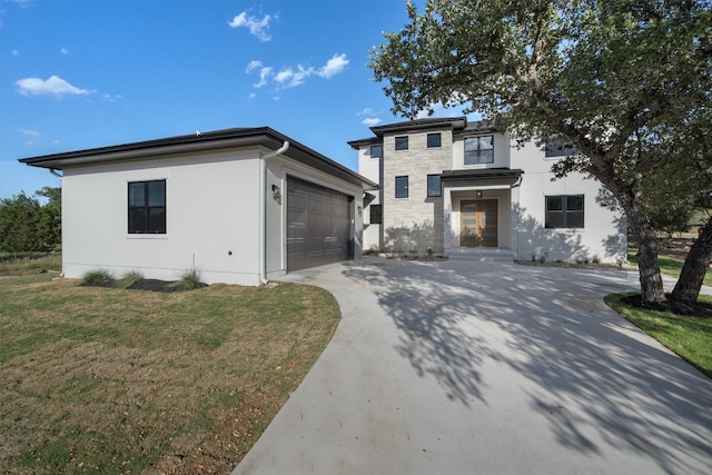 prairie-style house with a garage and a front lawn