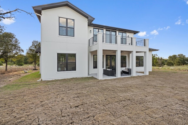 back of house with a patio area and a balcony