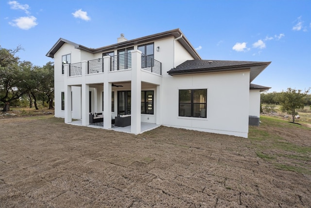 rear view of house featuring a patio area and a balcony