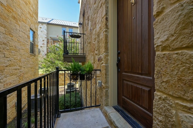 entrance to property featuring a balcony and central AC unit