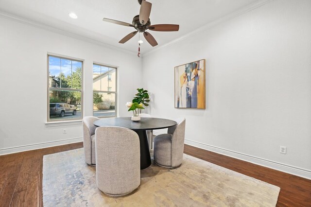 dining room featuring hardwood / wood-style flooring, crown molding, and ceiling fan