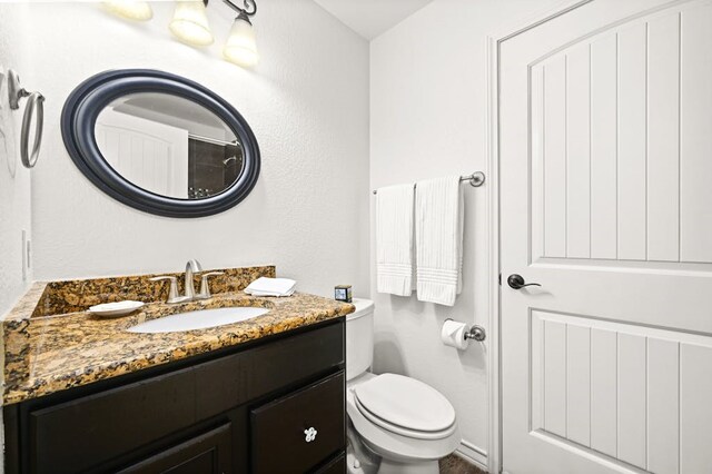 bathroom with toilet and vanity