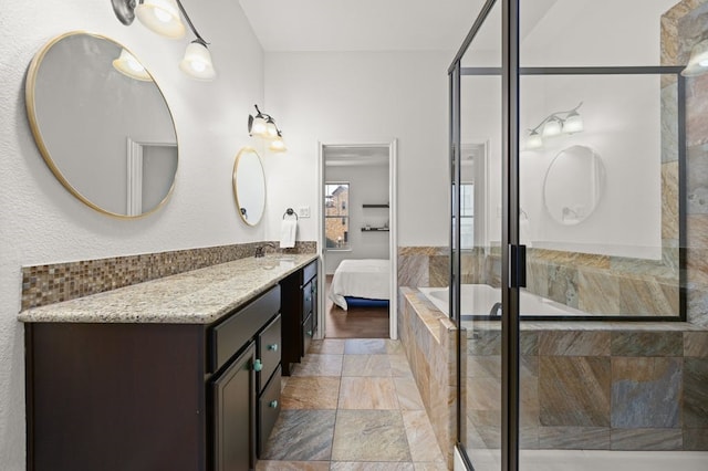 bathroom with separate shower and tub, vanity, and hardwood / wood-style floors