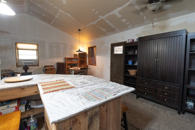 interior space featuring ceiling fan, carpet flooring, cooling unit, and lofted ceiling