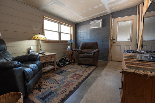 living room featuring vaulted ceiling, a wall unit AC, and brick wall