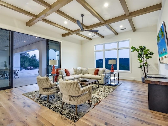 living room featuring coffered ceiling, beamed ceiling, baseboards, and wood finished floors