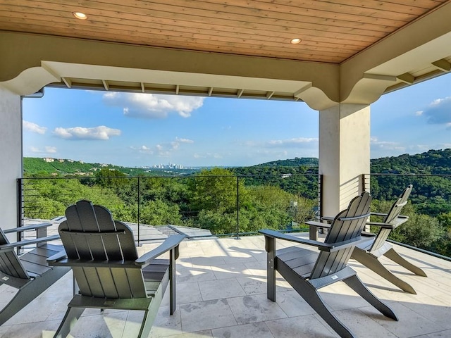 view of patio / terrace with a wooded view