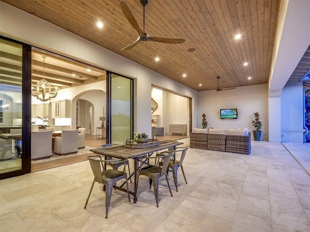 dining room featuring arched walkways, ceiling fan with notable chandelier, wooden ceiling, and recessed lighting