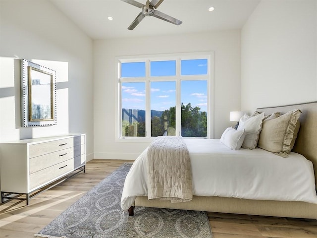 bedroom featuring light wood finished floors, recessed lighting, a mountain view, ceiling fan, and baseboards