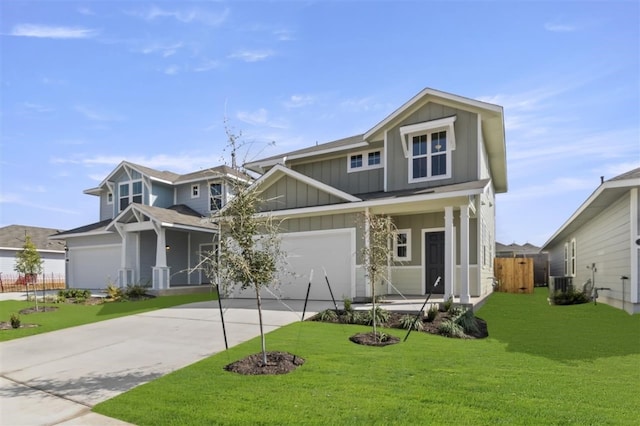 craftsman inspired home with cooling unit, a garage, and a front yard