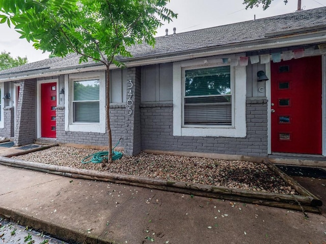 property entrance with brick siding