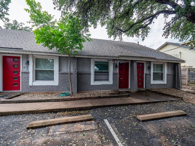 3465 Willowrun Dr, Austin, TX 78704 - view of front of home featuring brick siding, uncovered parking, and roof with shingles