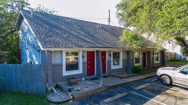 3465 Willowrun Dr, Austin, TX 78704 - view of front of home with brick siding, roof with shingles, and uncovered parking