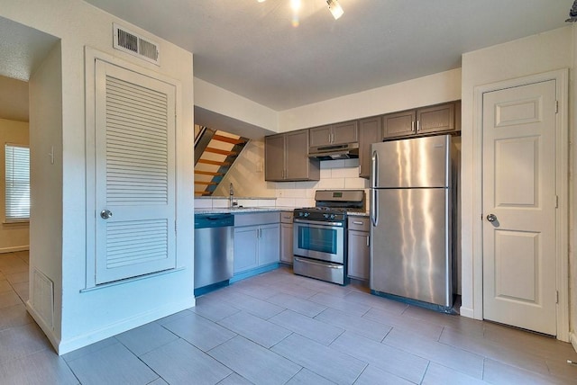 3465 Willowrun Dr, Austin, TX 78704 - kitchen featuring appliances with stainless steel finishes, under cabinet range hood, and a sink