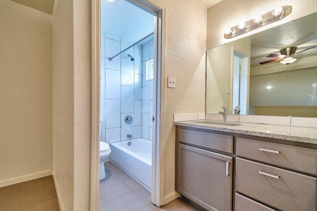3465 Willowrun Dr, Austin, TX 78704 - bathroom featuring a textured wall, toilet, vanity, washtub / shower combination, and baseboards