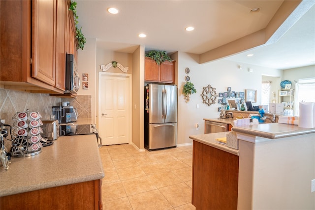 kitchen with backsplash, stainless steel appliances, and light tile patterned floors