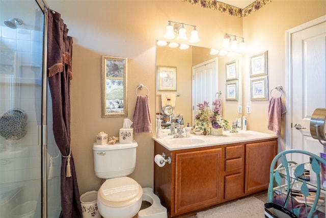 bathroom featuring toilet, an enclosed shower, and vanity