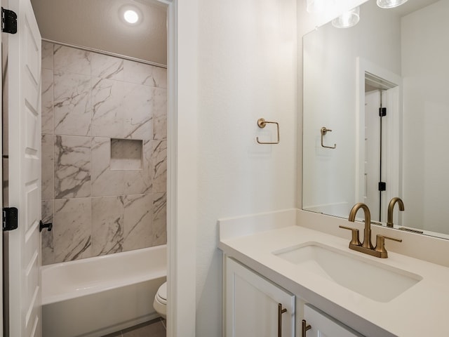 full bathroom featuring vanity, toilet, and tiled shower / bath